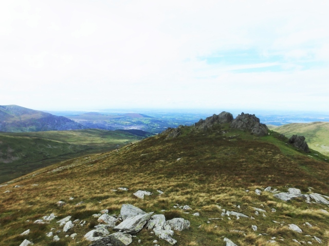Looking back at the rocky top of Foel Ganol